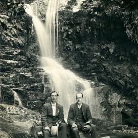 Two gentlemen seated in front of a waterfall, possibly in the Blue Mountains. Postcard, [n.d.]