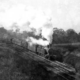 NSWGR C30 Class 4-6-4 Suburban Tank Locomotive on passenger passes a D53 Class 2-8-0 standard goods locomotive on the Main Northern Line, in Sydney Suburbs, [1930s]