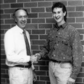 Professor Adrian Page congratulates an unidentified student, the University of Newcastle, Australia