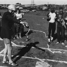 Baseball team members look on as Professor Godfrey Tanner christens the University of Newcastle's Baseball field with a bottle of beer, Australia