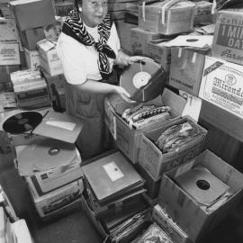 Ms. Pat Flowers, Convenor of the Friends of the University Book Fair inspects a record in preparation for the Book Fair, the University of Newcastle, Australia - 1990