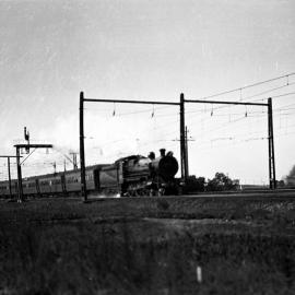 NSWGR C35 Class 4-6-0 Type Express Passenger Locomotive hauling the "Caves Express" near Rookwood, [1930s]