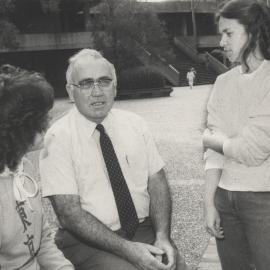 Mr Ted Miller conversing with two unidentified students, the University of Newcastle, Australia