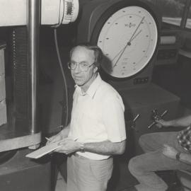 Dr Adrian Page, brick masonry testing facility with Maurie Dann sitting on the seat, the University of Newcastle, Australia - October, 1986