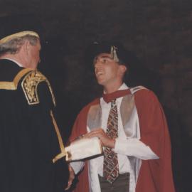 Chancellor Ric Charlton congratulates a graduate at the Faculty of Science / Maths graduation ceremony, the University of Newcastle, Australia - 9 May 1997, 6pm