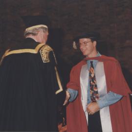 Chancellor Ric Charlton congratulates a graduate at the Faculty of Science / Maths graduation ceremony, the University of Newcastle, Australia - 9 May 1997, 6pm