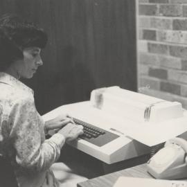 Anne Robinson using latest computer technology,  Auchmuty Library, 1970s