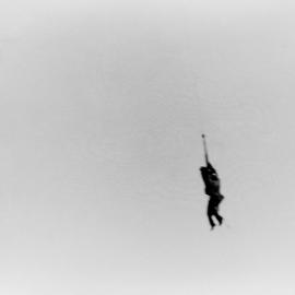 A man being rescued during the 1955 Maitland Flood: Lucey Collection