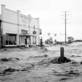 Flood waters outside [Sim Bros. NRMA] during the Maitland Flood, 1955: Lucey Collection