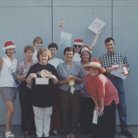 Leanne Turnbull, [Gail Travan?], [Unidentified] Margaret Trzcinka, Marta Rossignoli, Bronwyn Nelson, Marguerite McLellan, Dawn Byrnes, Helen Cluff, Greg Anderson, at a Library Christmas Party, Auchmuty Library Roof Garden, the University of Newcastle, Au