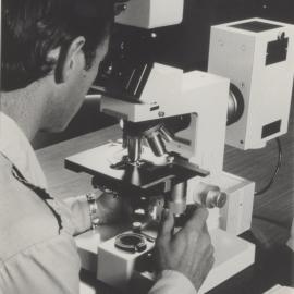Scientist using a microscope at the University of Newcastle, Australia