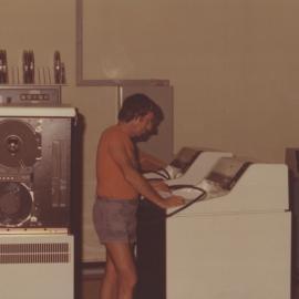 John Lambert, director of the computer centre - Photograph taken at the acquisition and installation of the University's VAX 11-780 computer, c. 1980