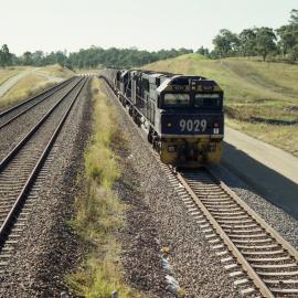 9029 and two other ninety classes wait for the road just south of Camberwell Junction, NSW