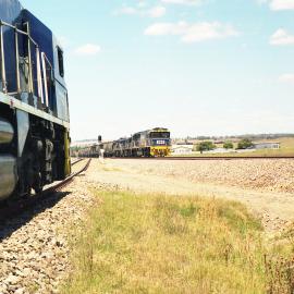 At Glennies Creek 8223 and two 48 class locos head north as a coal train waits for the road off the Mt. Owen Branch.