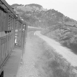 Two 48 class locos climb the hill from Antiene on a ballast train.