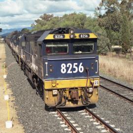 8256 and its train seen from the down starter at Quipolly, NSW