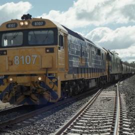 8107 and a G class on an up grain train at Quipolly, NSW