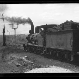 TGR C Class, pushing passenger carriage tender-first, driver leaning out of cab, unidentified location [n.d.]