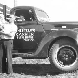Lindsay (Charlie Snr) Cook holding his son Charles (Charlie) Cook, and John Blundell pictured with Charlie Snr's Ford work truck owned by B. Hestelow, Carrier, Kurri Kurri, 1941 