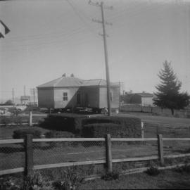 House being moved on the back of a truck. Photo taken from the Cook’s front yard in about 1956.