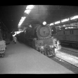 Victorian Railways R class locomotive, No. 719, at covered railway station, unidentified location, [n.d.]