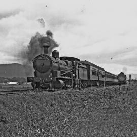 NSWGR D50 Class No. 5052 Standard Goods Locomotive on passenger train near Wollongong, [1930s]