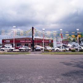 Stormy sky over Fren's Holden car yard, Kurri Kurri, NSW, December 1987