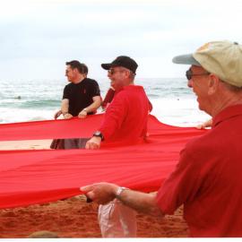 Giant red ribbon for World AIDS Day Newcastle Beach