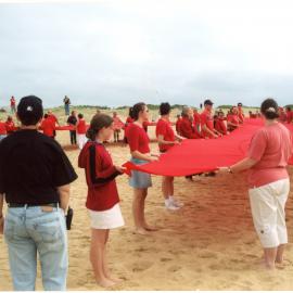 Giant red ribbon for World AIDS Day Newcastle Beach