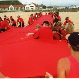 Giant red ribbon for World AIDS Day Newcastle Beach