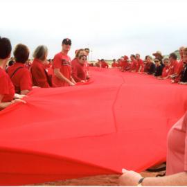 Giant red ribbon for World AIDS Day Newcastle Beach