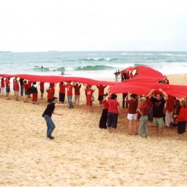 Giant red ribbon for World AIDS Day Newcastle Beach