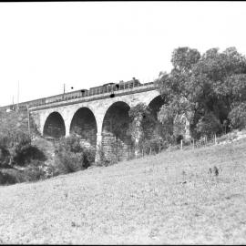 NSWGR stone viaduct, C36 Class locomotive and passenger carriages, unidentified location, rural [n.d.]