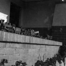 Model locomotives, image 2 of 3, showing a 4-4-0 and a 0-4-4T with goods wagons, unknown date and location.