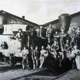 Railway depot crewmen posing with Victorian Railways tank locomotive no. 40 and locomotive [no. 70], large sheds behind, Spencer Street locomotive shed, [1880s]