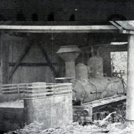 Derelict locomotive in shed, probably old logging Shay, unidentified location, [n.d.]