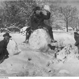 Three unidentified soldiers enjoy the snow at the Perham Downs camp in Wiltshire, England