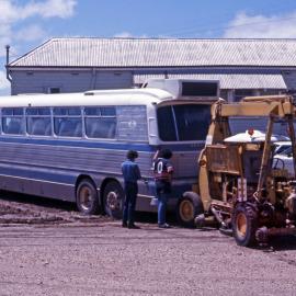 PTC GM Denning Coach MO-4702 bogged + tow vehicle DYS-511, Walgett Railway Station, NSW, 1 November 1976