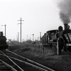 Locomotive 5486 'Down Coal train' at Hexham crossing 5262 in Brown’s Siding, Hexham NSW, 1 September 1972