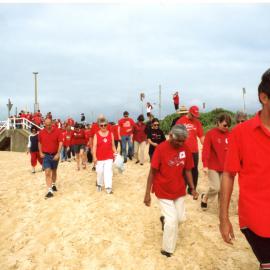 Crowd assembles for Giant Red Ribbon unfurling  for World AIDS Day; Judith Gatland; Newcastle Beach