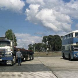 Ford Semi trailer CAW-131, LGB Leyland Atlantean MBI-003 (1003), service station, Pacific Highway nth of Wyong, NSW, 13 September 1986