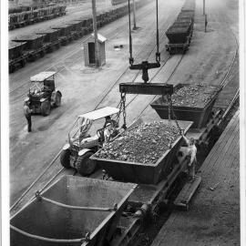 Connecting lifting chains to steel hopper, West Basin electric cranes, 1956 