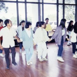Dancing students holding hands - Medical Communication Unit, the University of Newcastle, Australia