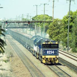 8254, another 82 class and an 81 class at the head of unit 21 approaching Waratah on their way to a mine in the Hunter Valley