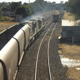 As a Glencore coal train heads north on the down coal road at Waratah, 8213 and a classmate drift along the up coal road
