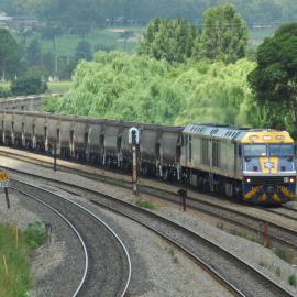 EL57 and a classmate with unit 49 are about to pass Victoria Street, East Maitland, on their way to Pelton, NSW, 15 January 2015