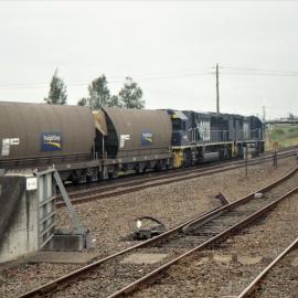 A pair of ninety class locos with a rake of Batwings heading north at Maitland, NSW, May 2002