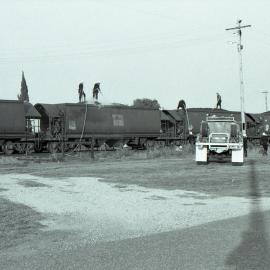 Burning coal in coal hoppers being extinguished at Singleton, NSW, September 1986
