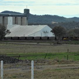 An Aurizon loaded coal train passing the silos as it approaches Werris Creek, NSW, 1 August 2015