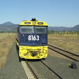 8163 with a grain train at Coggan Creek during a crew change, September 1997